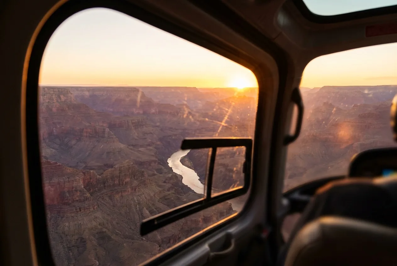 Golden sunset light across the Grand Canyon photographed from a helicopter window